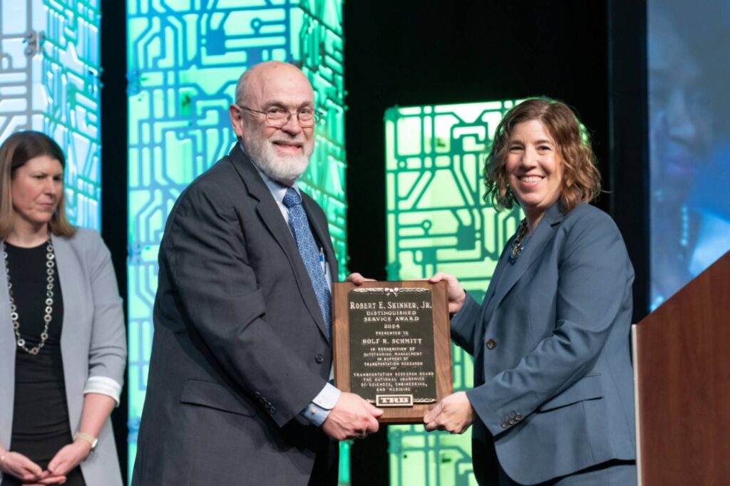 Leslie Rogers presents Skinner Award to Rolf R. Schmitt at the 2025 TRB Annual Meeting.