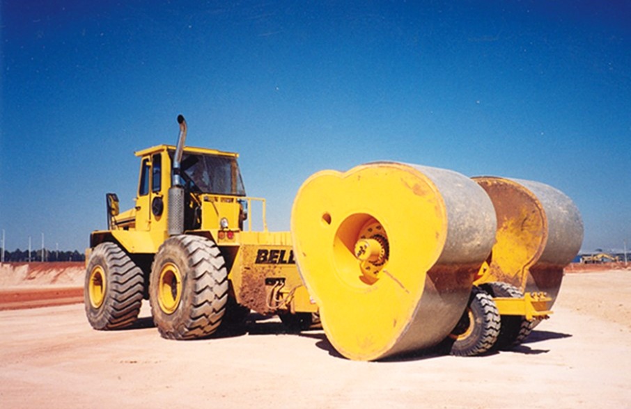 Yellow noncircular impact compactor with three-sided wheels