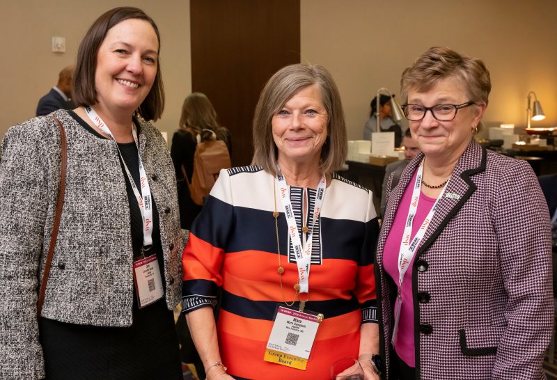 Jennifer Duval, Mara Campbell, and Lorraine Martin stand together smiling.