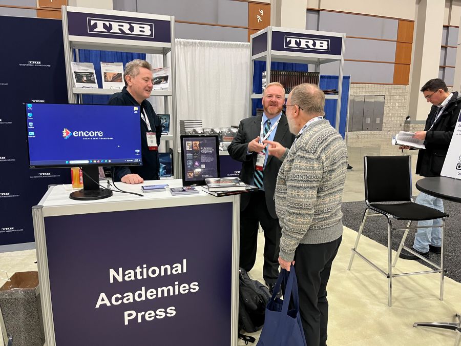 Gary Walker and Scott Brotemarkle talking to attendee at the National Academies Press booth.