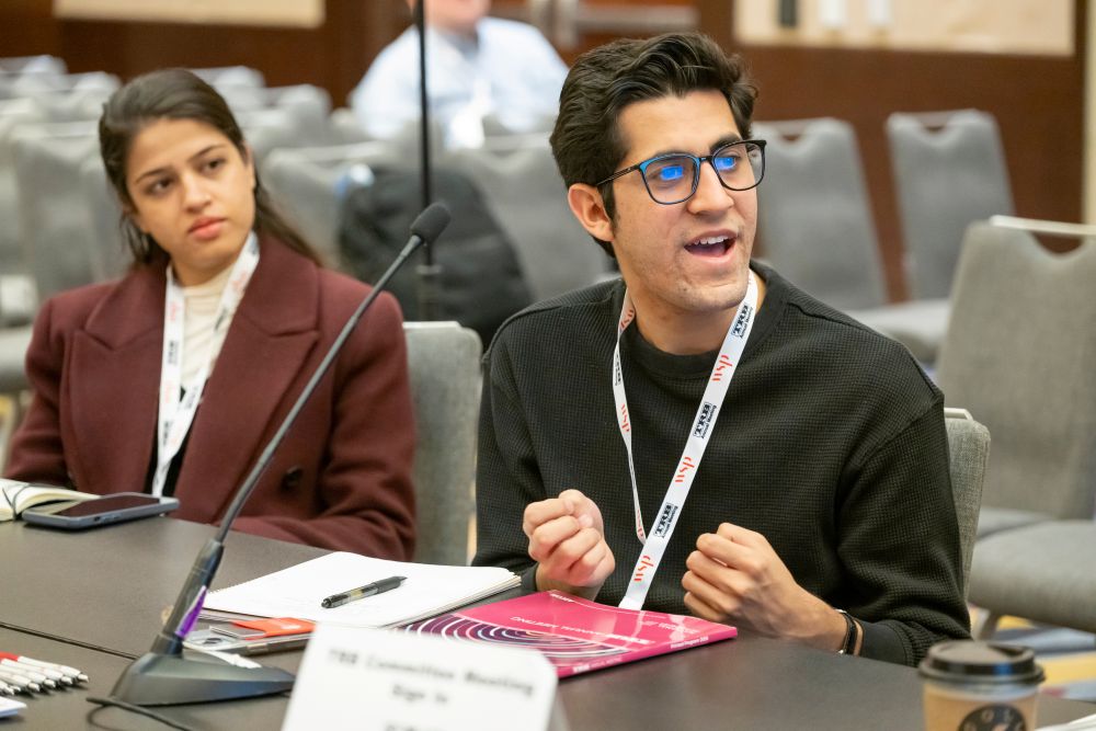 Ryan Zapata speaks during a meeting while Nisa Hafeez sits beside him listening.