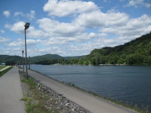 People walking on the paved Lock Haven Levee Trail along the West Branch Susquehanna River in Lock Haven, Pennsylvania.